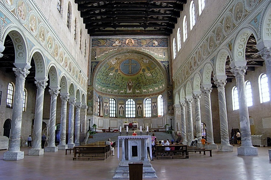 A view of the reliquary and beyond it the altar as seen through the nave. The stairs lead to the altar in the apse, which has five small arched windows.