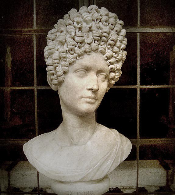 A marble bust of a woman with elaborately coifed hair.