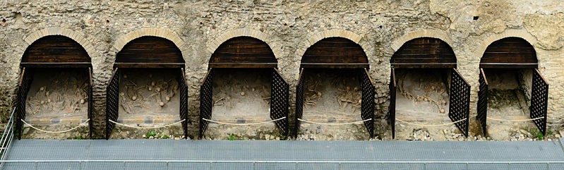 A row of arches with skeletons in each niche.