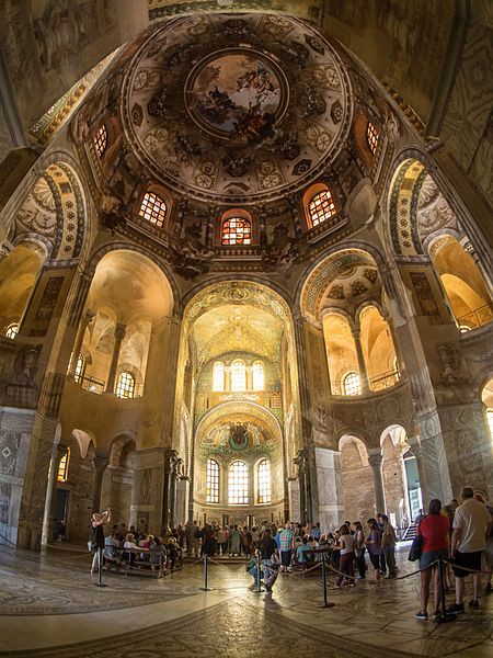 Stunning interior view from under the dome, facing the apse. People gather there. Mosaics cover nearly every surface.