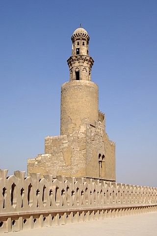 Top of the wall with stylized figures, and the minaret.