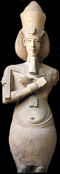 A large statue of the upper half of Akhenaten’s figure. He stands ceremoniously holding the crook and flail and wearing his false beard.