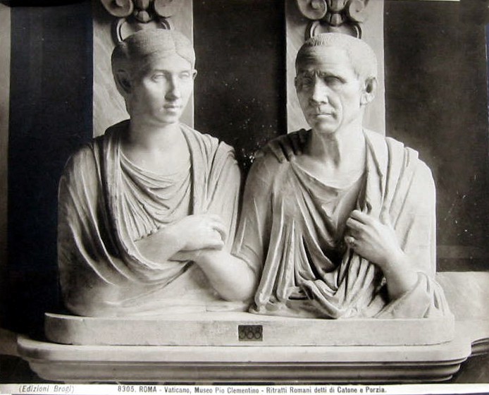 A marble carving of a couple who hold hands but do not look directly at each other.