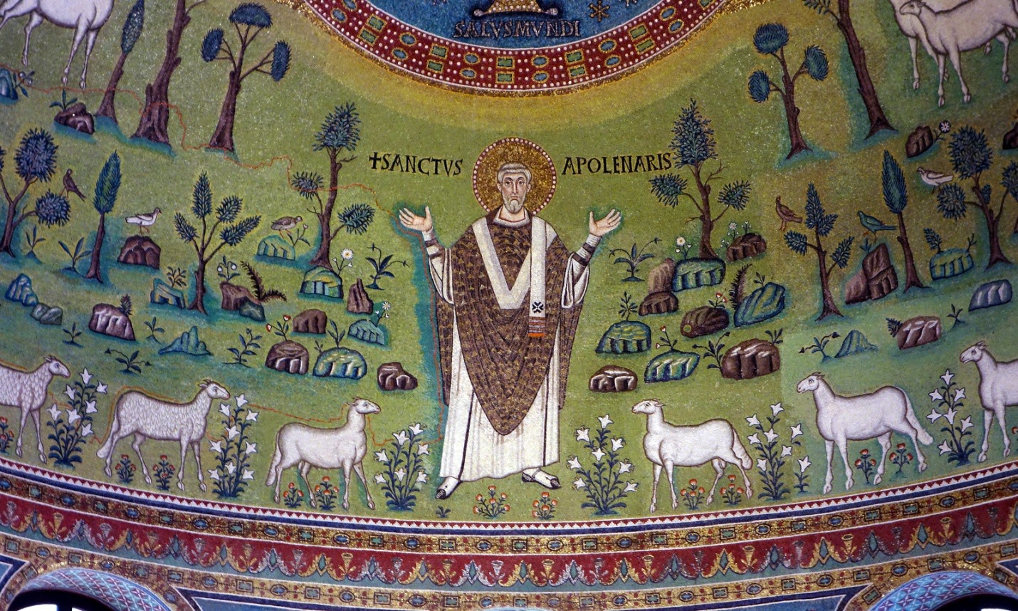 A close-up of the apse mosaic. Saint Apollinare with his halo stands with hands raised in a stylized meadow. He is surrounded by sheep.