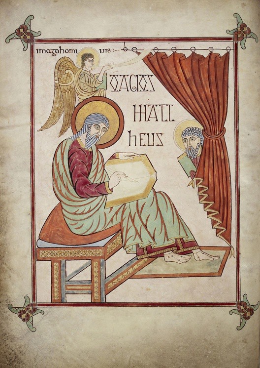 A page depicting Matthew writing in a book. An angel blows a horn above him as a bearded face peek from behind a curtain.