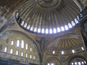 A view of the dome and semidome that includes an angel with four wings called a cherubim under the dome on a pendentive and between the semi-dome and an arch.