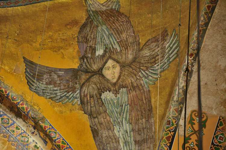 An angel with six wings and a face.