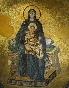 A close-up of Theotokos revealing Mary’s red outlined halo and her bule dress against a gold background. The child’s halo has a cruciform in it.