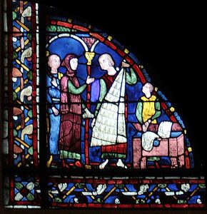 A part of a stained-glass window displaying Saint James in his job.