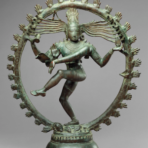 A bronze statue depicting a dancing man with four arms and flowing, snake-like hair. He is encircled by flames and tramples a tiny figure.