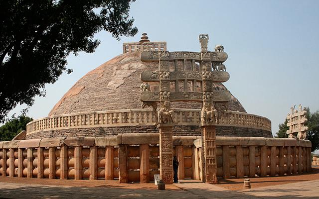 A dome shaped building surrounded by a short wall with a gate.
