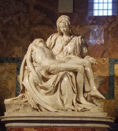 A sculpture of a robed woman seated and holding an apparently dead man in her lap.
