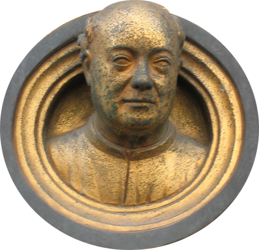 A bronze portrait of an older, balding man.