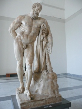 A massive, muscly man leaning on his club that is partly covered by a lion’s skin.