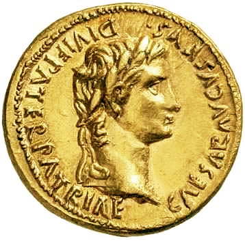 A gold coin with the profile of a young man on it. There is writing around his head.