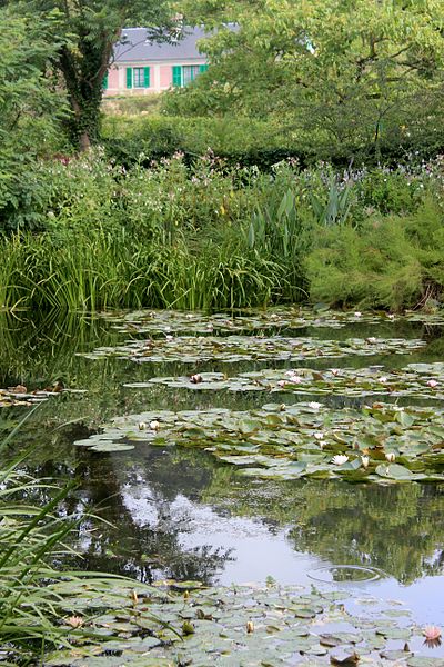 Monet’s House and Gardens at Giverny. Photograph of water lilly pond surrounded by Japanese style garden