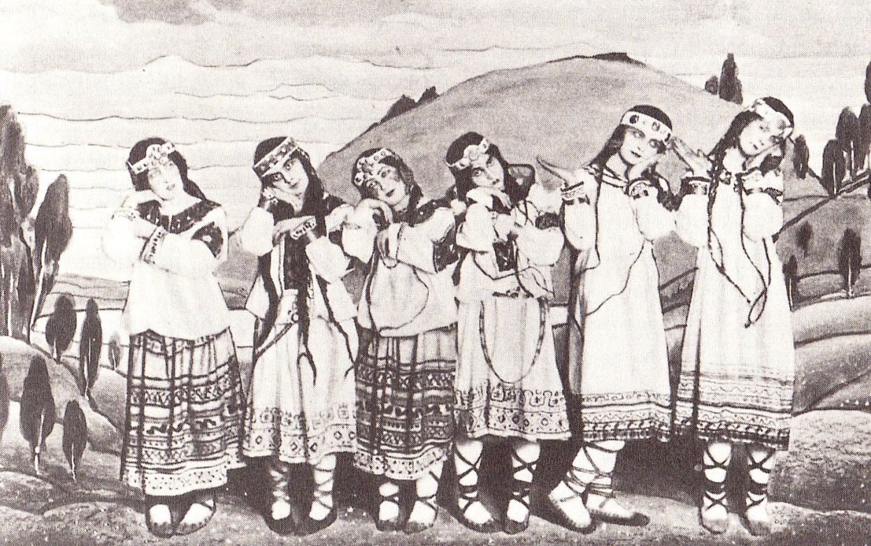A posed group of dancers in the original production of Igor Stravinsky's ballet The Rite of Spring, showing costumes and backdrop by Nicholas Roerich. The dancers are (left to right) Julitska, Ramberg (en:Marie Rambert), Jejerska, Boni, Boniecka, Faithful