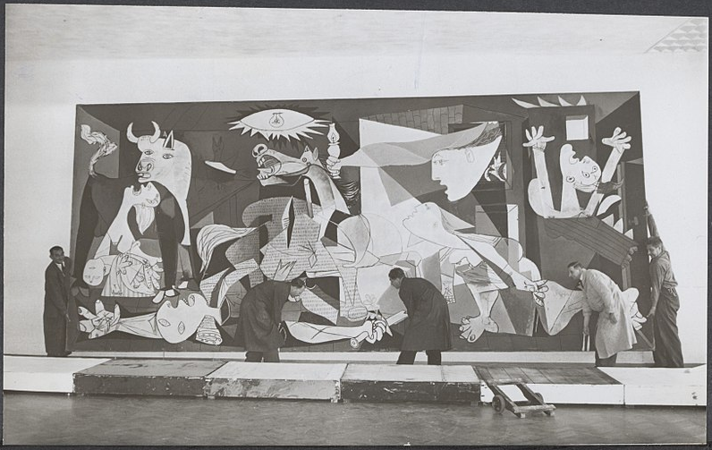 Pablo Picasso, Guernica, 1937, tempera on canvas, museum employees installing the painting in the Stedelijk Museum in Amsterdam.