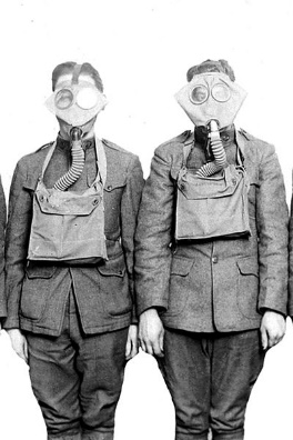 Two servicemen from the First World War wearing gas masks.