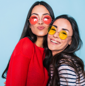 Ximena and Leticia, two Hispanic women with long, dark hair and sunglasses