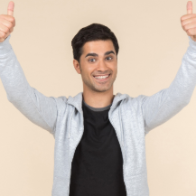 Gabriel, a young smiling Hispanic man with short, dark hair giving a thumbs up