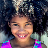 A pretty African-American child with curly hair.